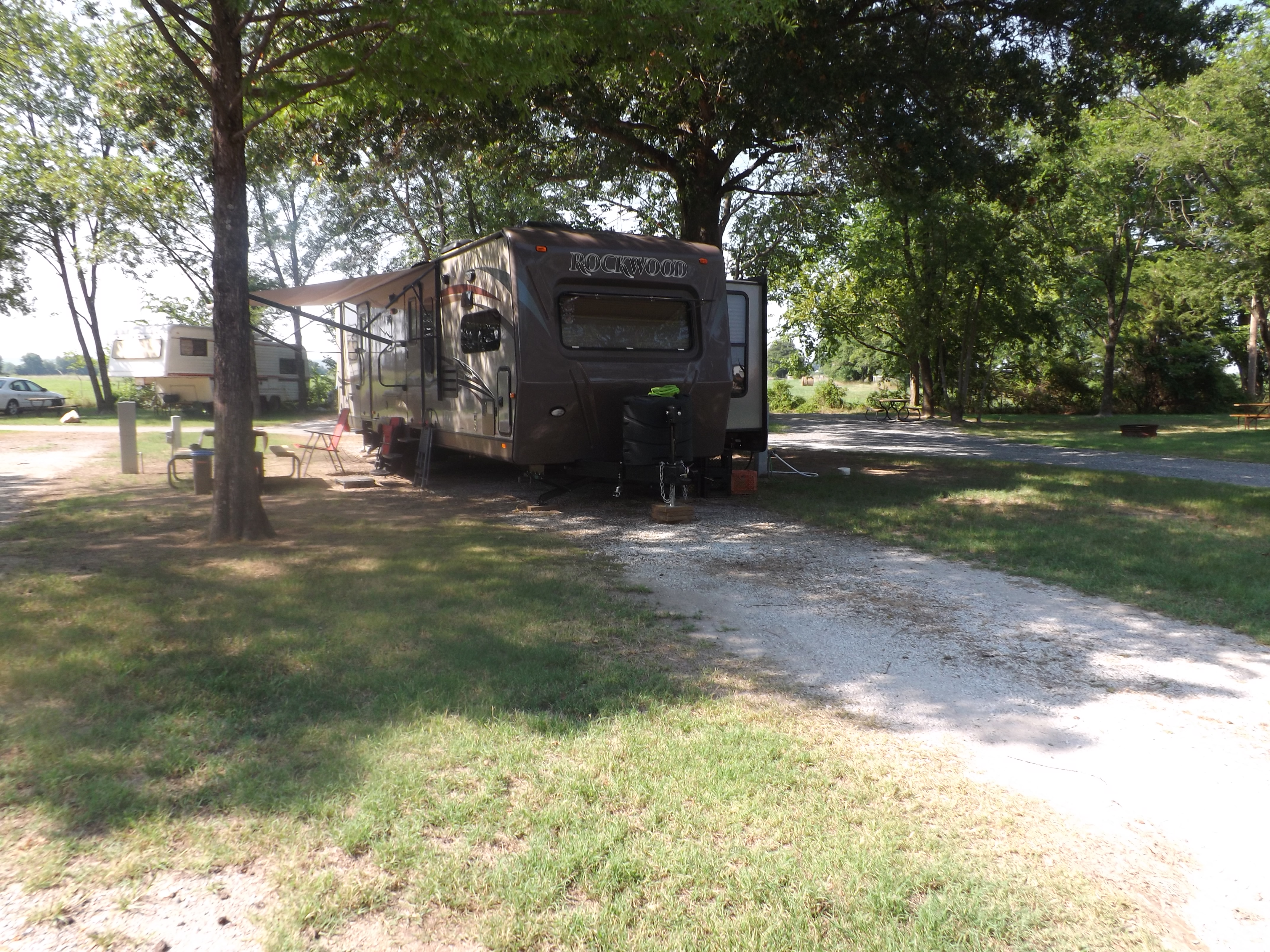 Long, pull-thru site with full hookups and large, mature, shade trees that are kept trimmed, even for the largest RVs.