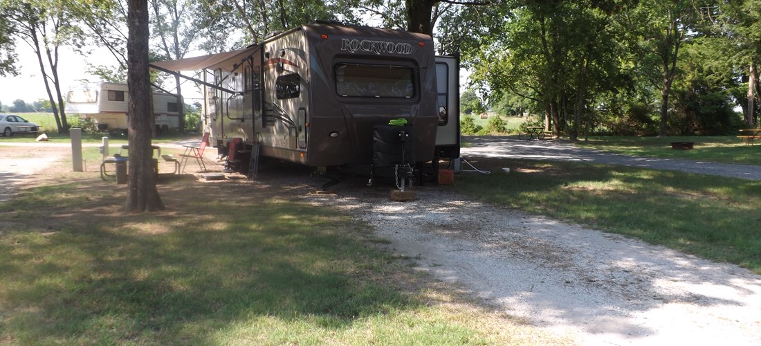 Long, pull-thru site with full hookups and large, mature, shade trees that are kept trimmed, even for the largest RVs.