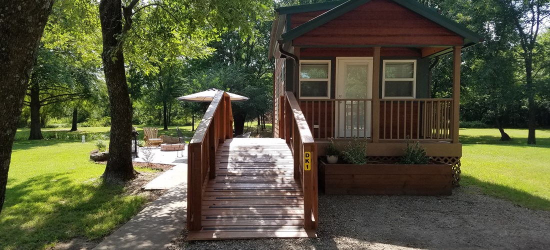 Covered front porch and ramp are just a few of the amenities with our deluxe cabin!