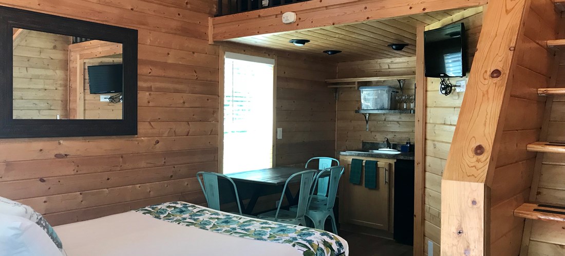 Our Studio Lodges are the perfect cozy solution for couples or a small family.  The Studio Lodge has a bed in the main room, a small kitchenette, bathroom with shower, gas bbq, picnic table and fire pit.