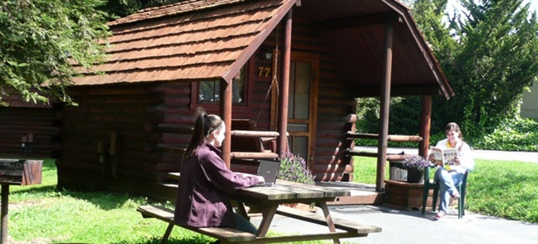 Our Camping Cabins feature a full bed, bunk beds, TV with cable, porch swing, picnic table, fire pit and Free WIFI. There is parking for 1 car. Extra vehicles may park for free in our lower parking lot.