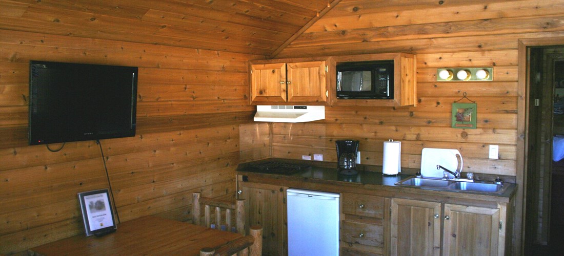 Our Deluxe Cabins even have televisions and the kitchen is well appointed.