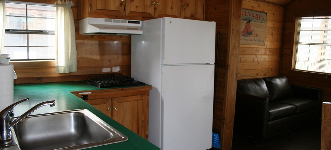 This Deluxe Cabin features a stovetop with a full size fridge.