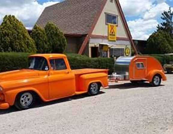 Low rider antique truck with matching tear drop camper.
