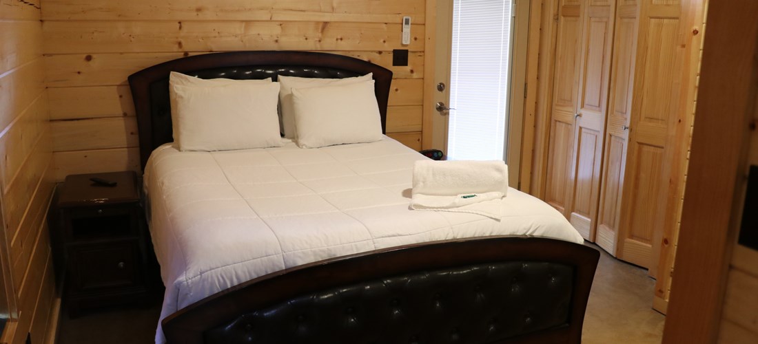 Our log cabins have a queen bed with an upgraded mattress in the bedroom.