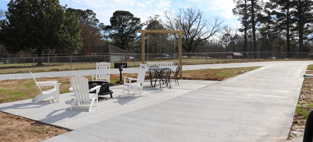 Our pull-thru premium sites with KOA Patios are everything you would imagine from a luxury campsite!  Extra long concrete pads with easy access, a large concrete patio complete with a grill, fire pit, patio furniture, a swing, and even an outdoor dining table and chairs!