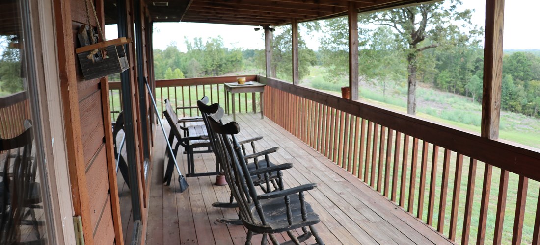 Relax on the back deck high above the trees at God's Country Lodge.