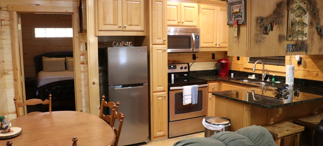 Our log cabins offer a full kitchen with granite countertops and modern appliances.