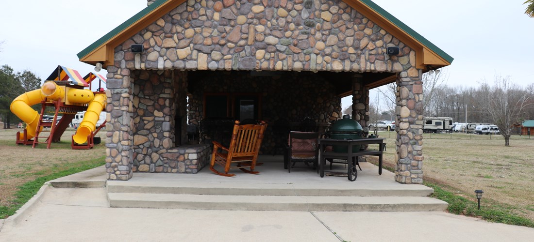 The pool house features not only a small cabin with a bedroom and bath, but also a nice outdoor kitchen area and patio complete with an outdoor fireplace and bar.