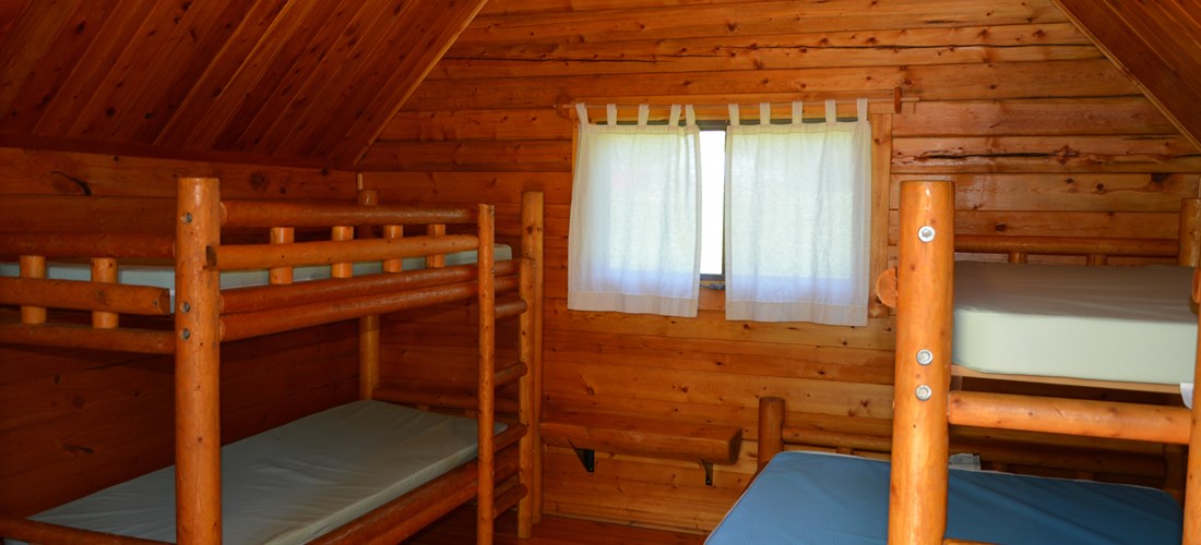 Inside 1 room camping cabin that sleeps 5.