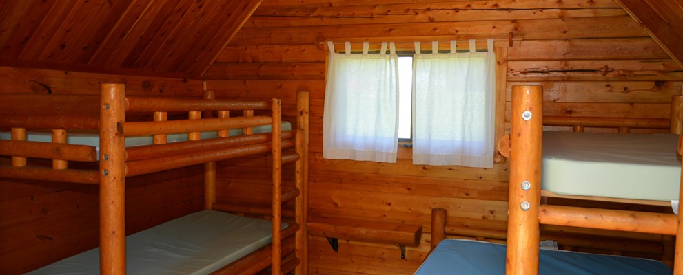 Inside 1 room camping cabin that sleeps 5.