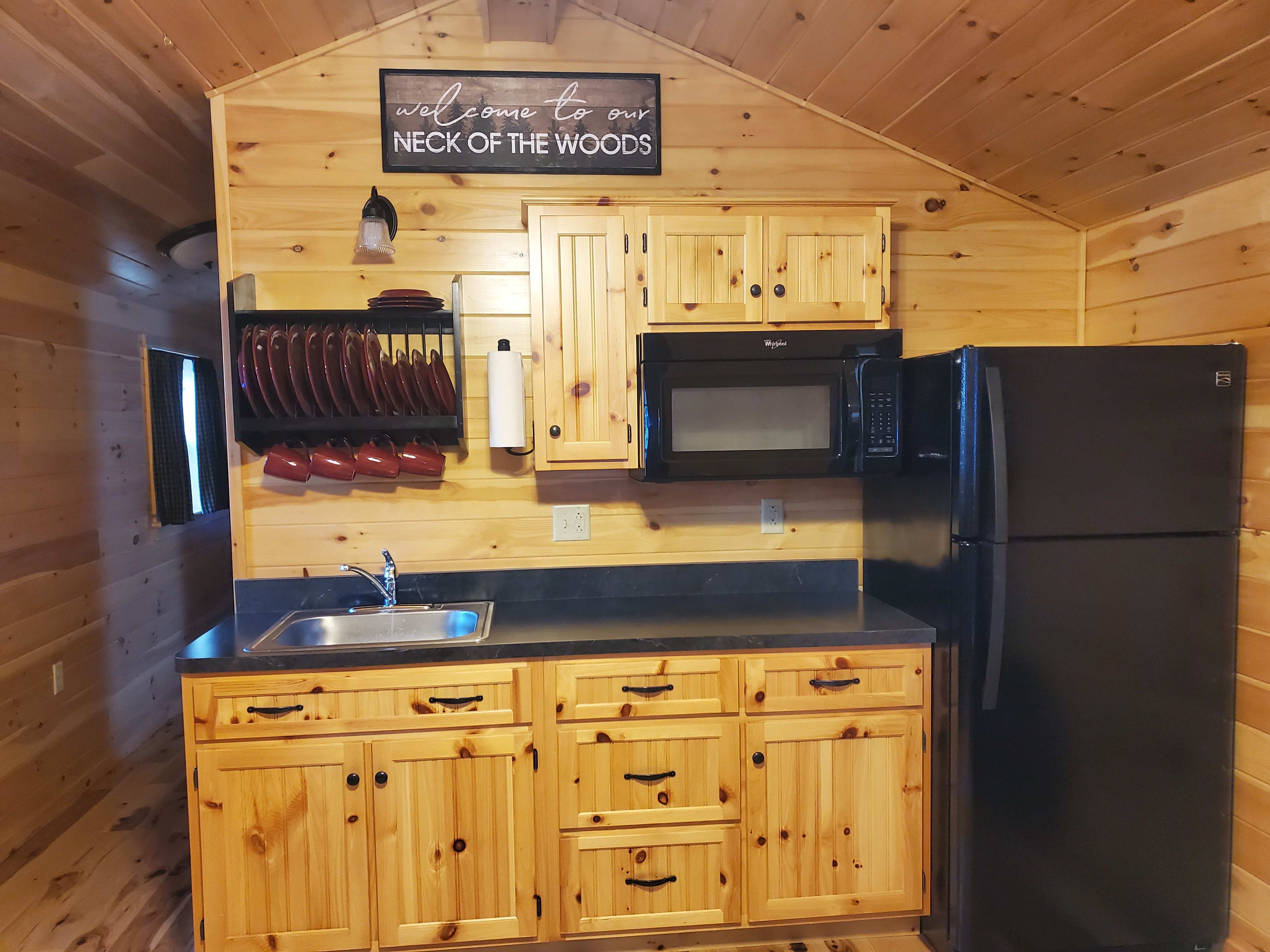 Moose Lodge Kitchen Living Room area- This area has a full size fridge, microwave, sink, futon, table and tv. 2 burner glass top stove will also be included