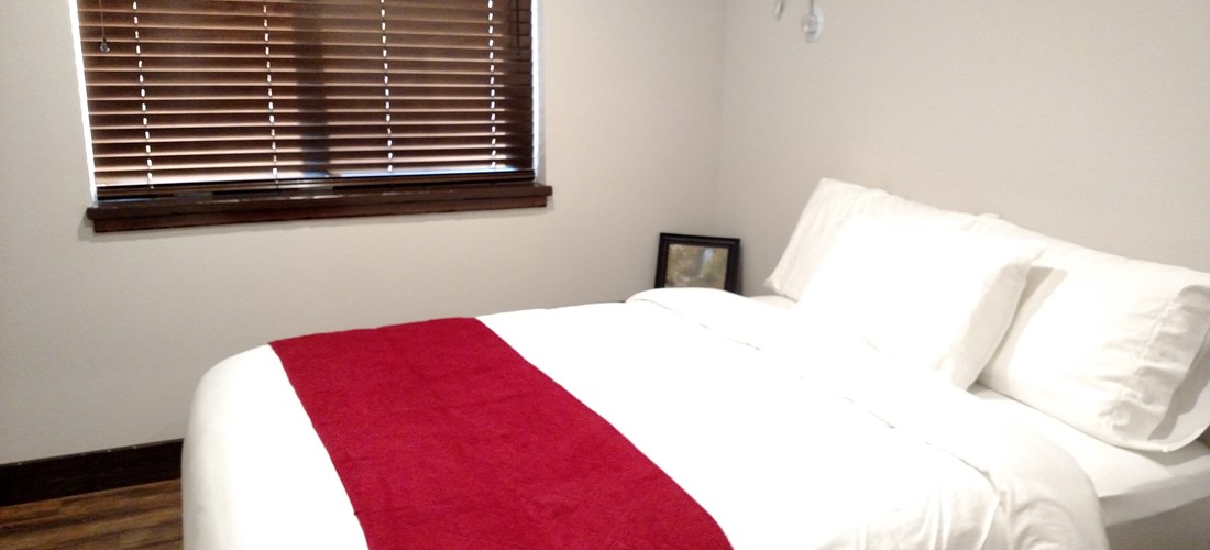 Queen bed in a two bedroom deluxe cabin