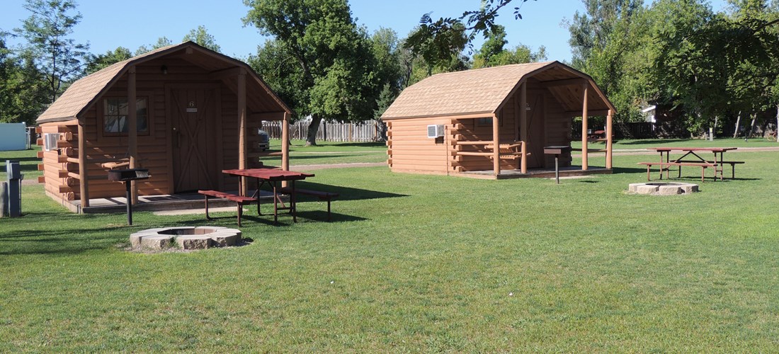 Our basic cabins have water, heat and air conditioning as well as a grassy lawn and a fire pit.