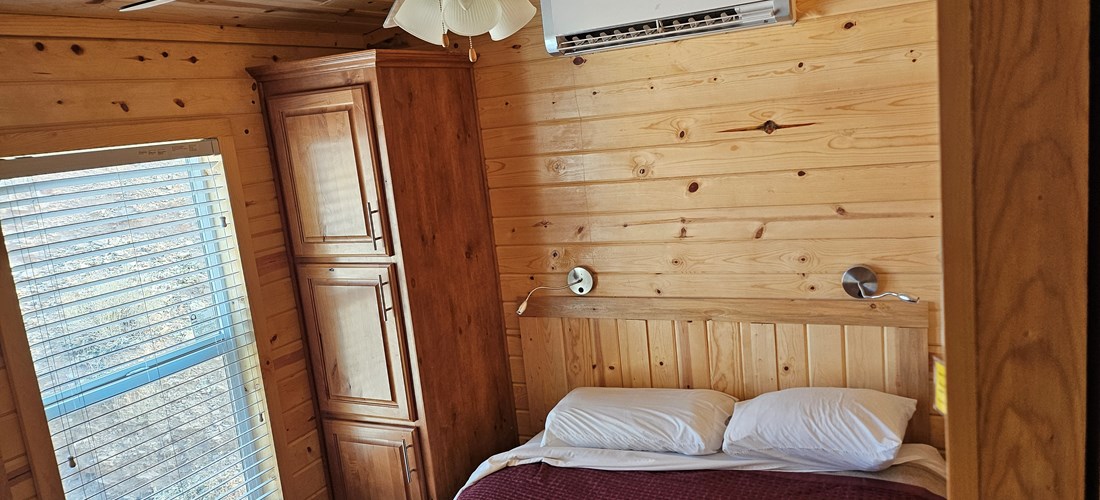Deluxe Family Lodge Bedroom 1 has storage, heat, AC, and fan for your comfort