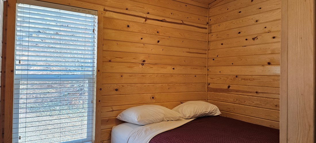 Deluxe Family Lodge Bedroom 2 with storage, heat, AC, and ceiling fan for comfort