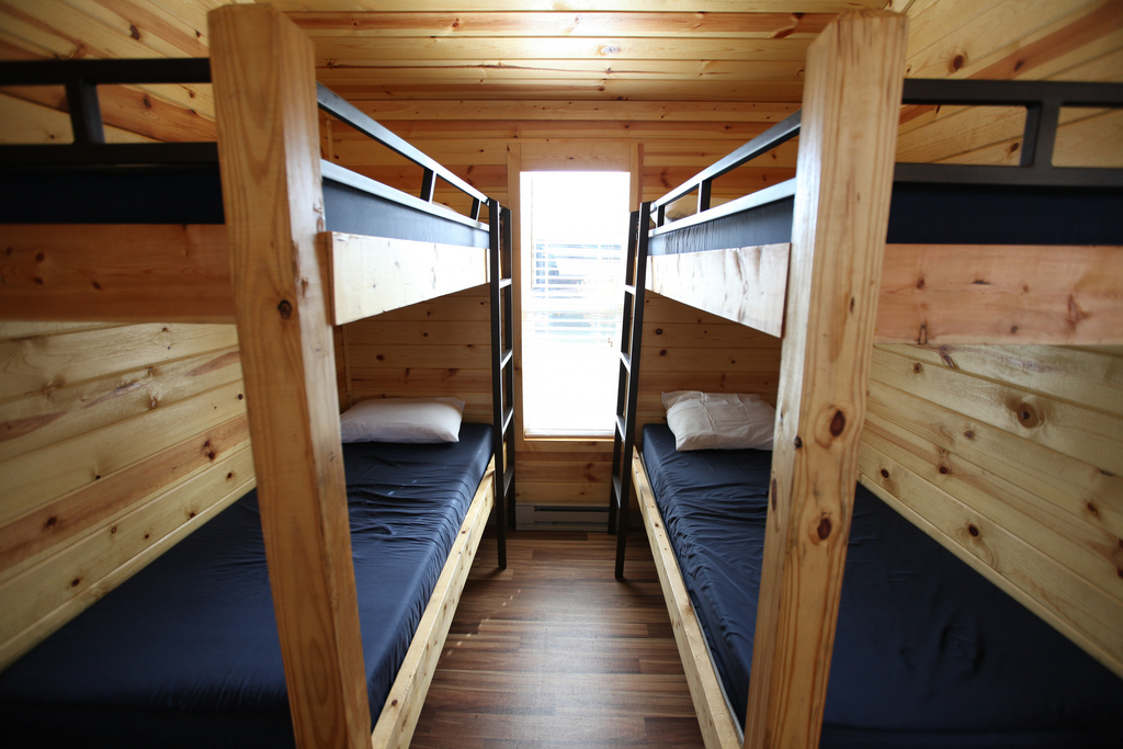 This cabin can sleep up to eight people, with accommodations in the double bunk bed room, on the pull-out couch, and queen bed.