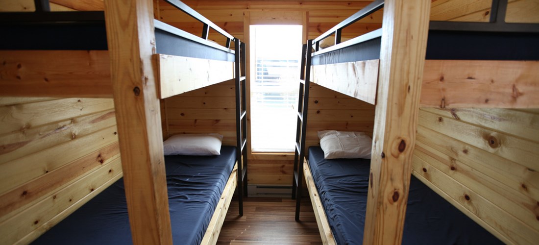 This cabin can sleep up to eight people, with accommodations in the double bunk bed room, on the pull-out couch, and queen bed.