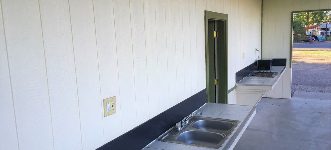 Kitchen at camper pavilion with 2 double sinks and hot/cold water. Electrical outlets available here as well.
