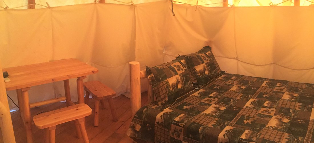 Queen bed with table and chairs.