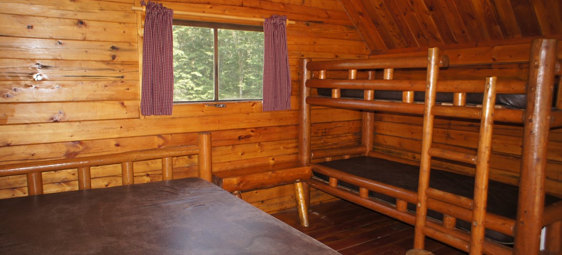 Classic Cabins offer sleeping for up to 2 adults and 2 children on comfortable full bed and bunk bed set.