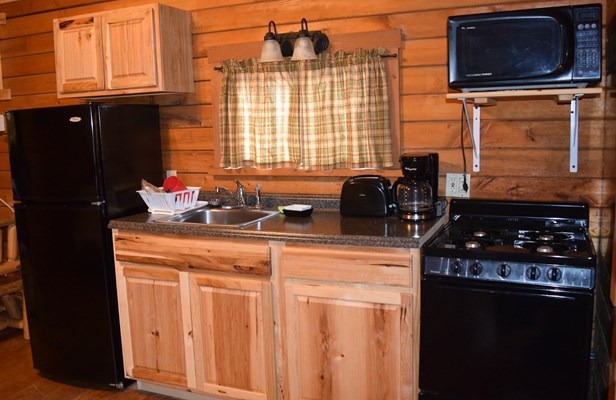 The kitchen area of our Country Cottage is spacious and comes with a full fridge, stove, toaster, microwave, and all of your kitchenware.