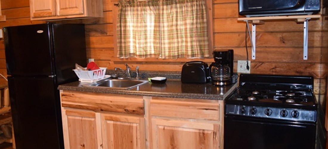 The kitchen area of our Country Cottage is spacious and comes with a full fridge, stove, toaster, microwave, and all of your kitchenware.