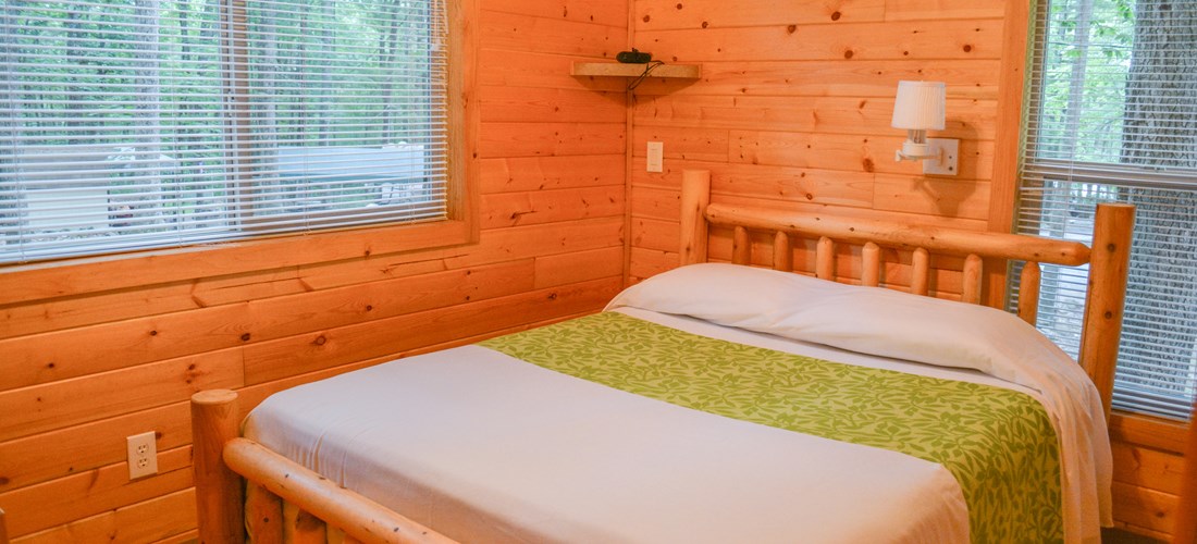 The bedroom includes a queen bed and linens are provided.
